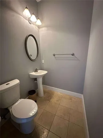 a bathroom with a toilet a sink and a mirror