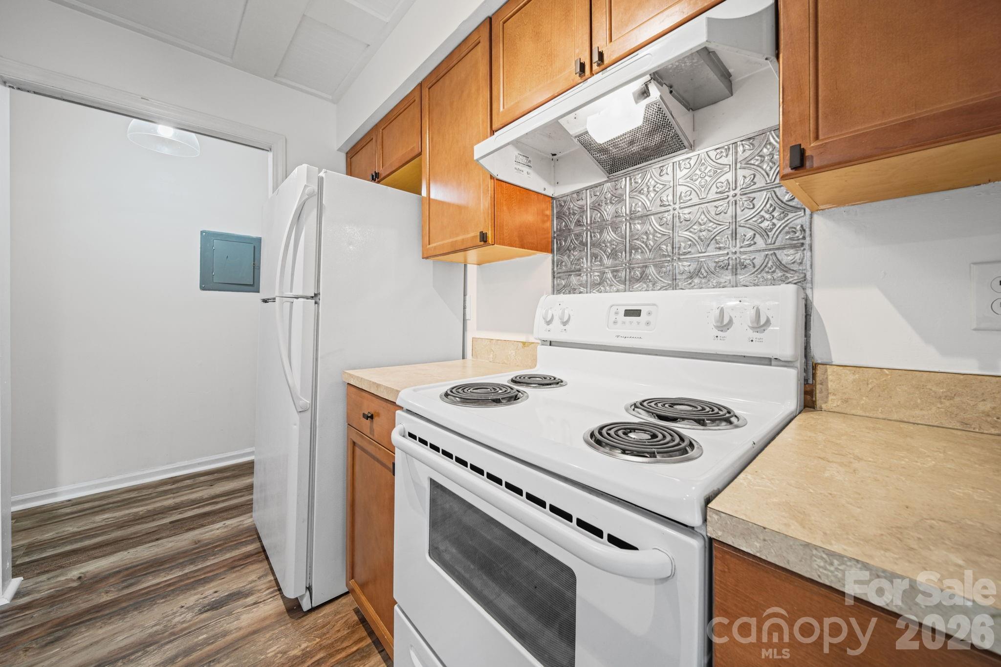 11023 Harrowfield Road Charlotte, NC 28226 - Photo 11 of 32 a kitchen with a stove and a white refrigerator