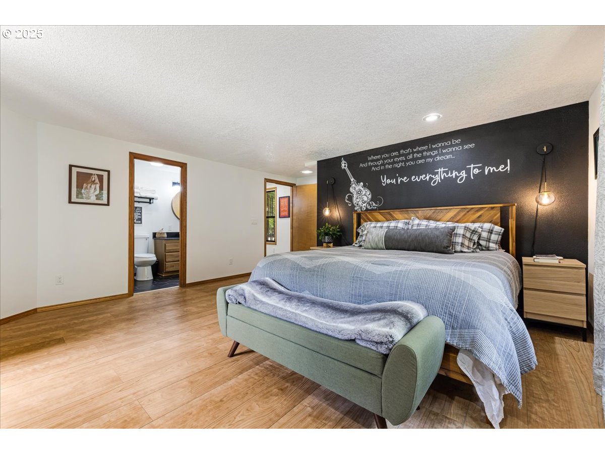 1717 Kalama River Road Kalama, WA 98625 - Photo 11 of 48 a bedroom with a bed and lamp