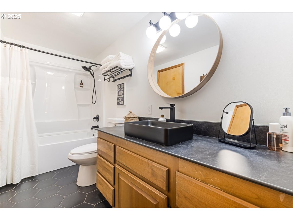 1717 Kalama River Road Kalama, WA 98625 - Photo 12 of 48 a bathroom with a double vanity sink toilet mirror and bathtub