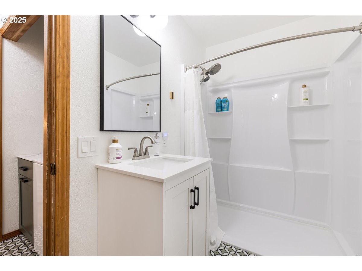 1717 Kalama River Road Kalama, WA 98625 - Photo 27 of 48 a bathroom with a sink a mirror and a shower