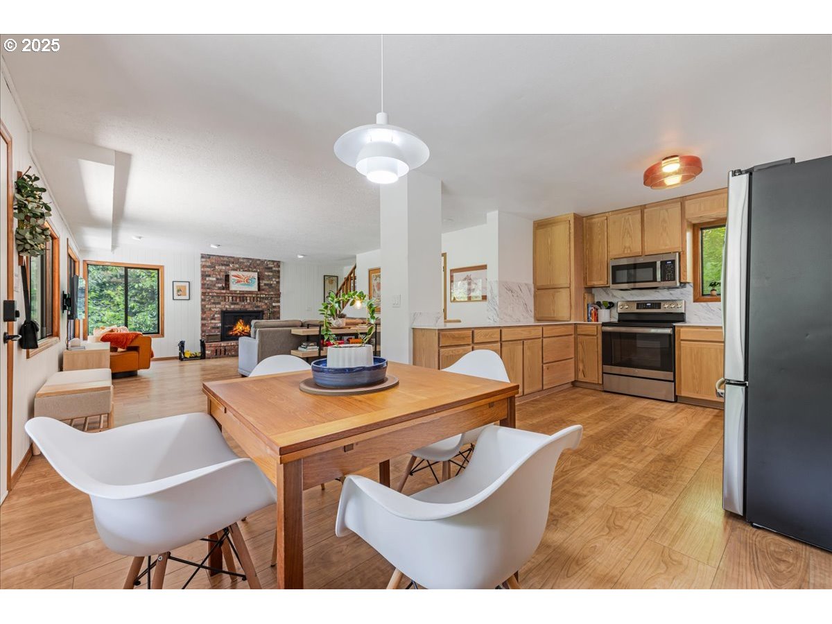 1717 Kalama River Road Kalama, WA 98625 - Photo 29 of 48 a kitchen with a table chairs and refrigerator