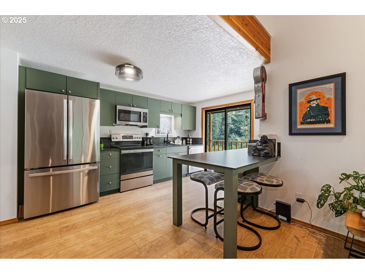 1717 Kalama River Road Kalama, WA 98625 - Photo 5 of 48 a kitchen with granite countertop a refrigerator and a stove top oven