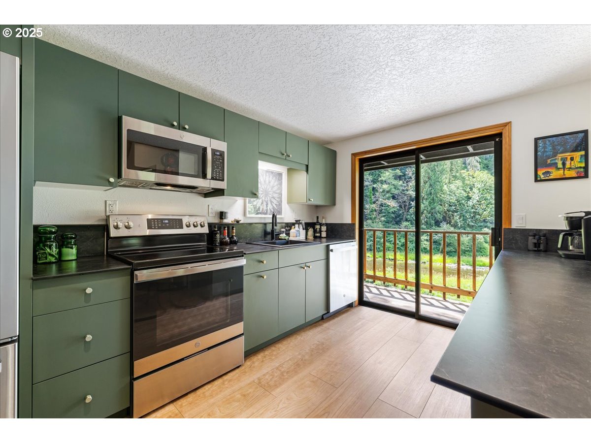 1717 Kalama River Road Kalama, WA 98625 - Photo 6 of 48 a kitchen with a stove a sink and a microwave