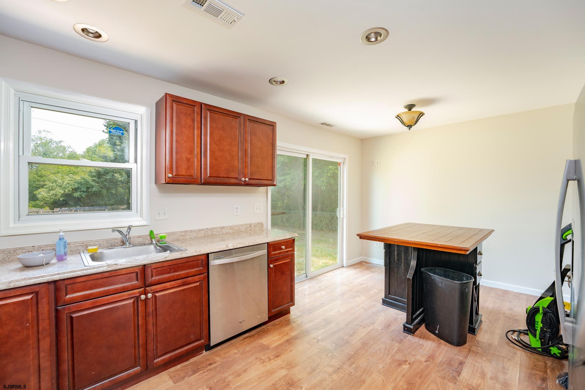 7 Folson Road Millville, NJ 08332 - Photo 13 of 41 a kitchen with stainless steel appliances granite countertop a stove a sink dishwasher and a refrigerator with wooden floor