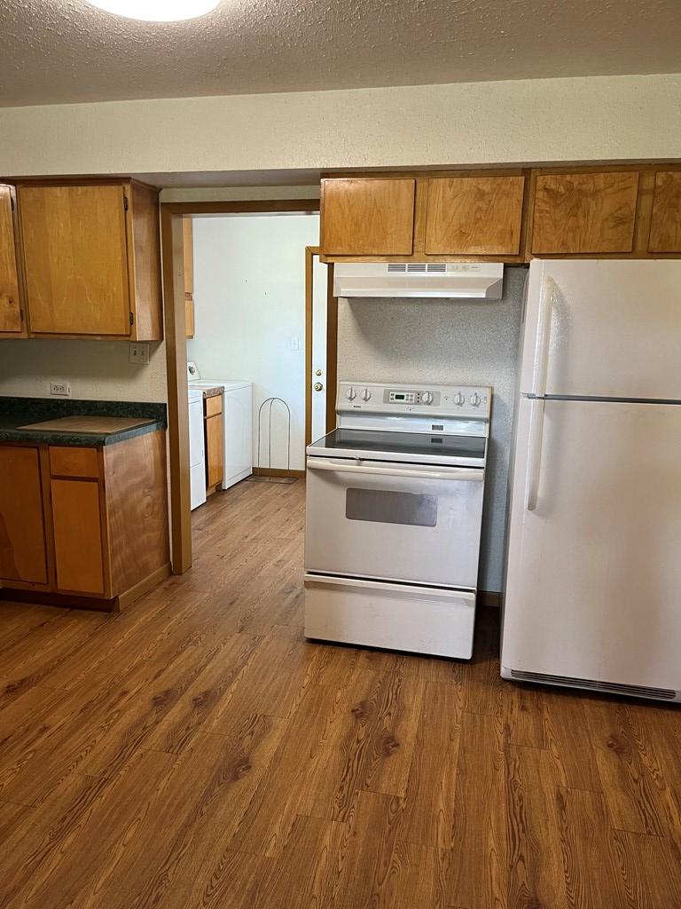 303 B 1st St Center Point Center Point, TX 78010 - Photo 5 of 11 a kitchen with a refrigerator and a stove