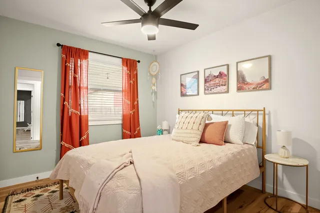 a bedroom with a large bed and a window