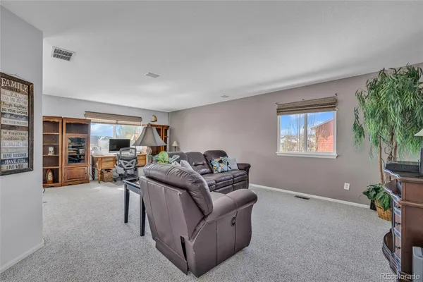 a living room with furniture and a potted plant