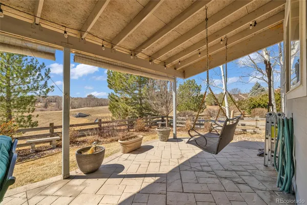 a view of a patio with a dining table and chairs