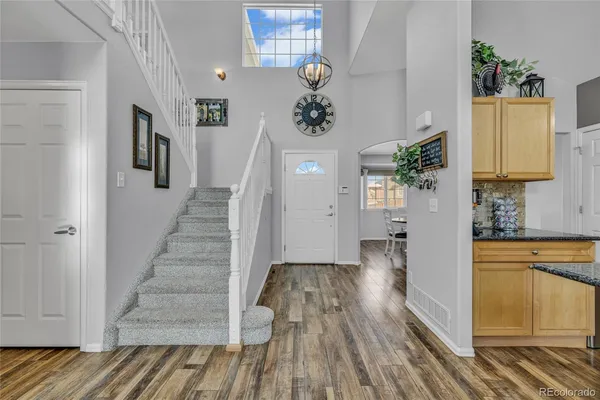 a view of a hallway view with wooden floor and staircase