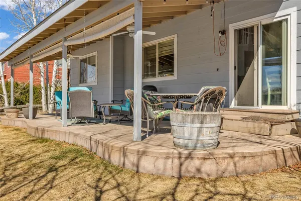 a view of a patio with a dining table and chairs