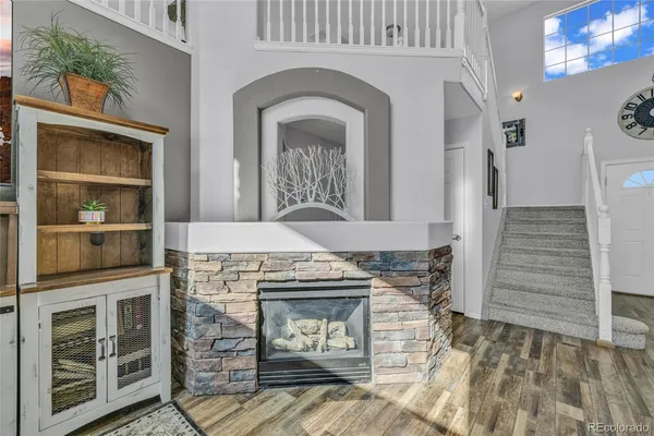 a view of living room with furniture and a fireplace