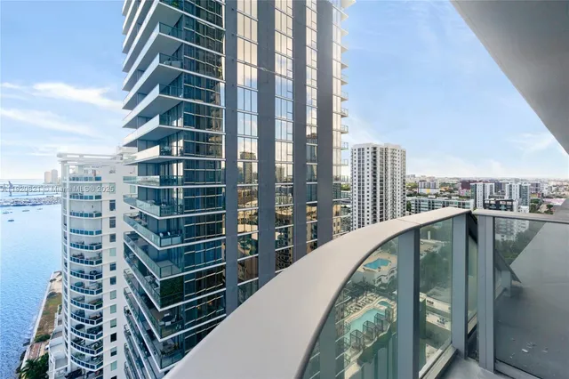 a view of an empty room with glass door and windows