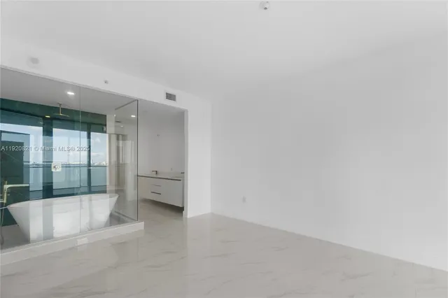 a view of an empty room with a window