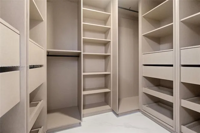 a living room with furniture a floor to ceiling window and a flat screen tv