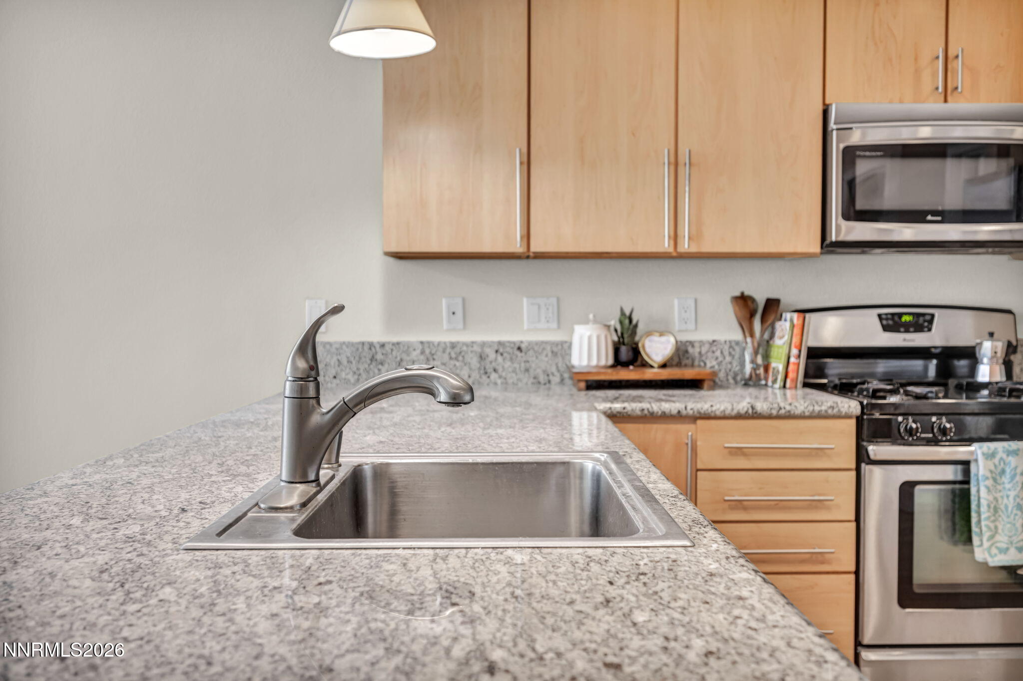 326 State Street Reno, NV 89501 - Photo 23 of 49 a kitchen with granite countertop a sink a stove and cabinets