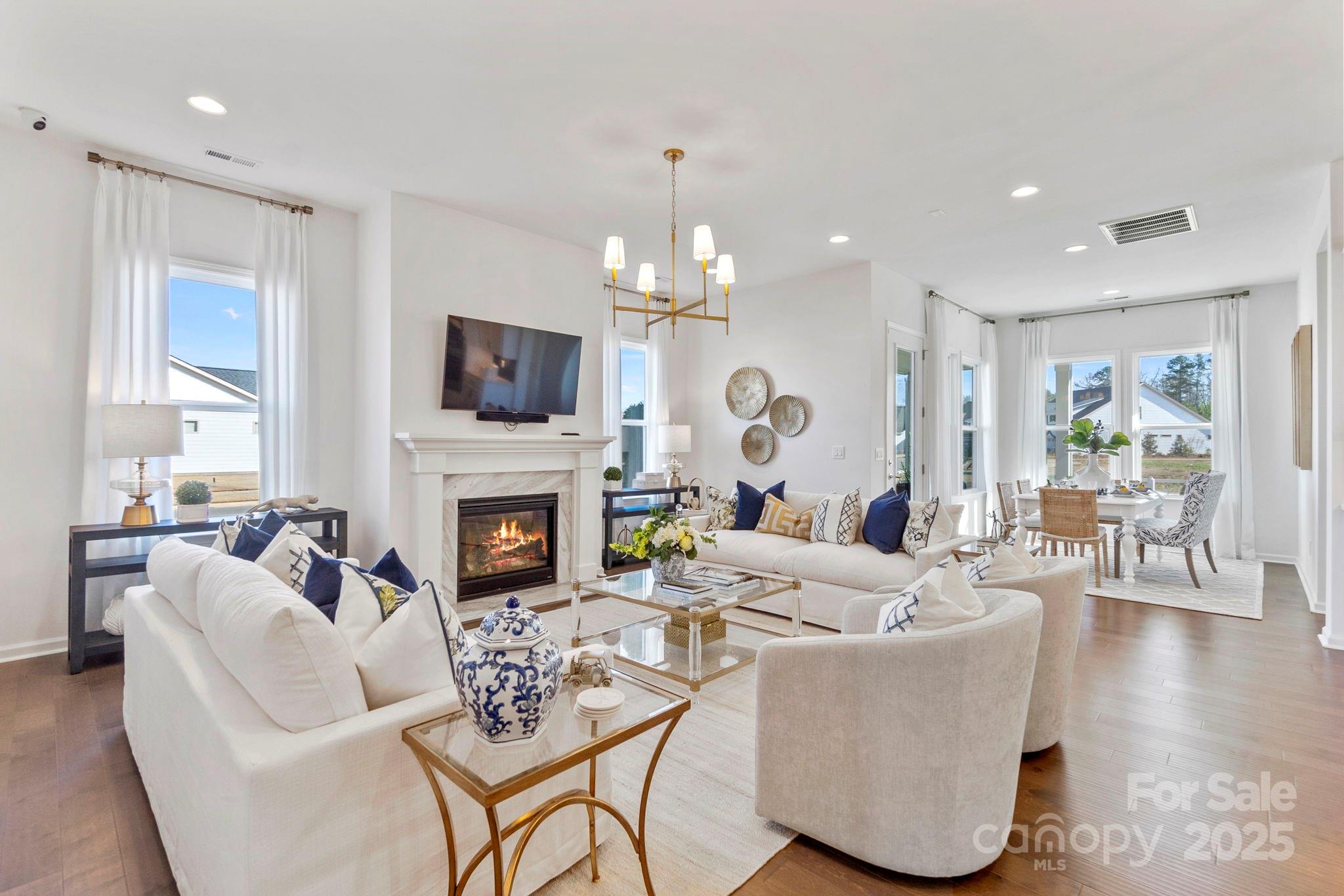 5068 Duval Circle Tega Cay, SC 29708 - Photo 11 of 41 a living room with furniture a fireplace and a flat screen tv