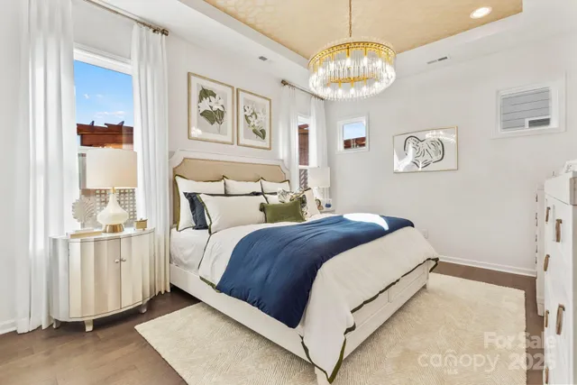 a bedroom with a bed and a chandelier