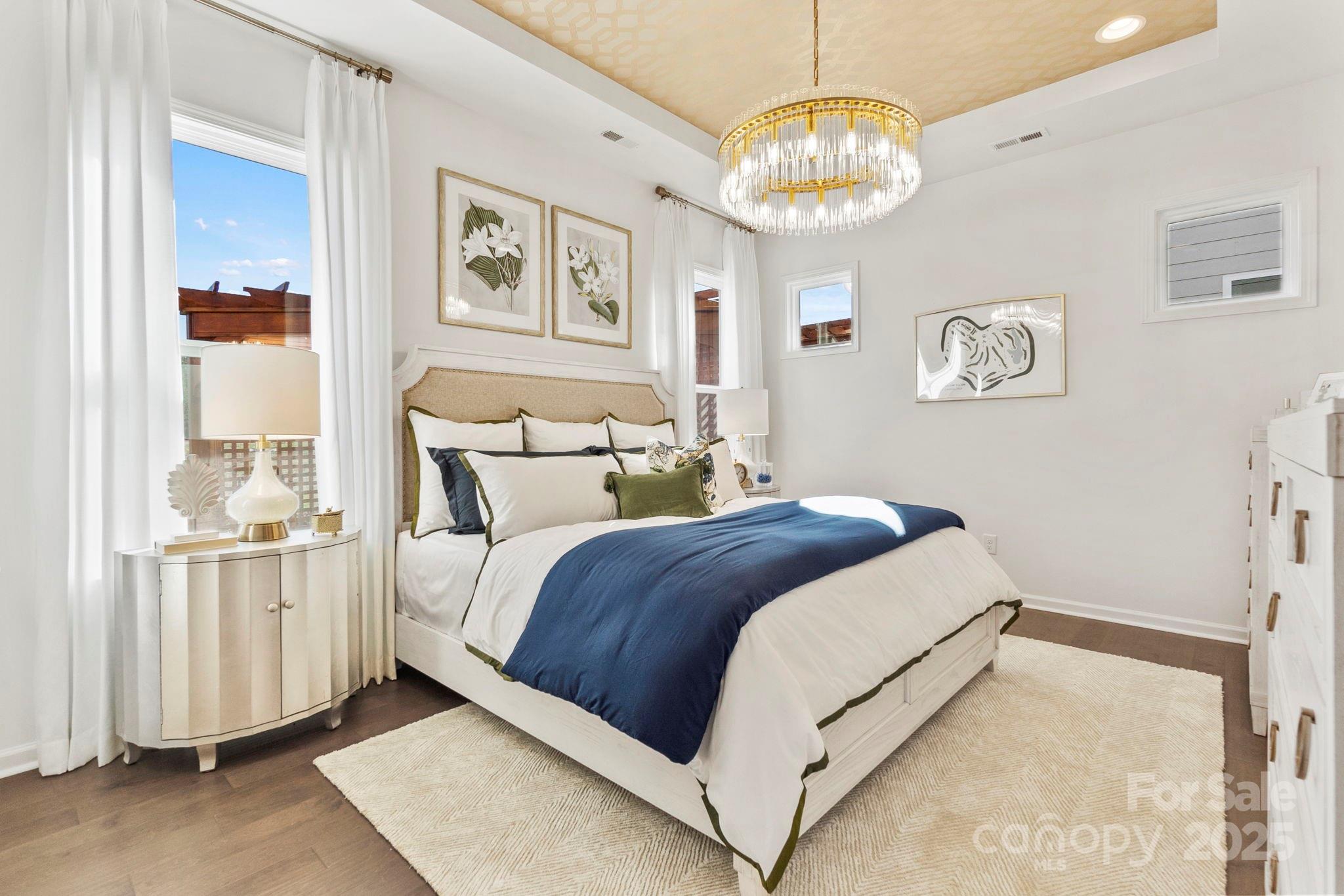 5068 Duval Circle Tega Cay, SC 29708 - Photo 16 of 41 a bedroom with a bed and a chandelier