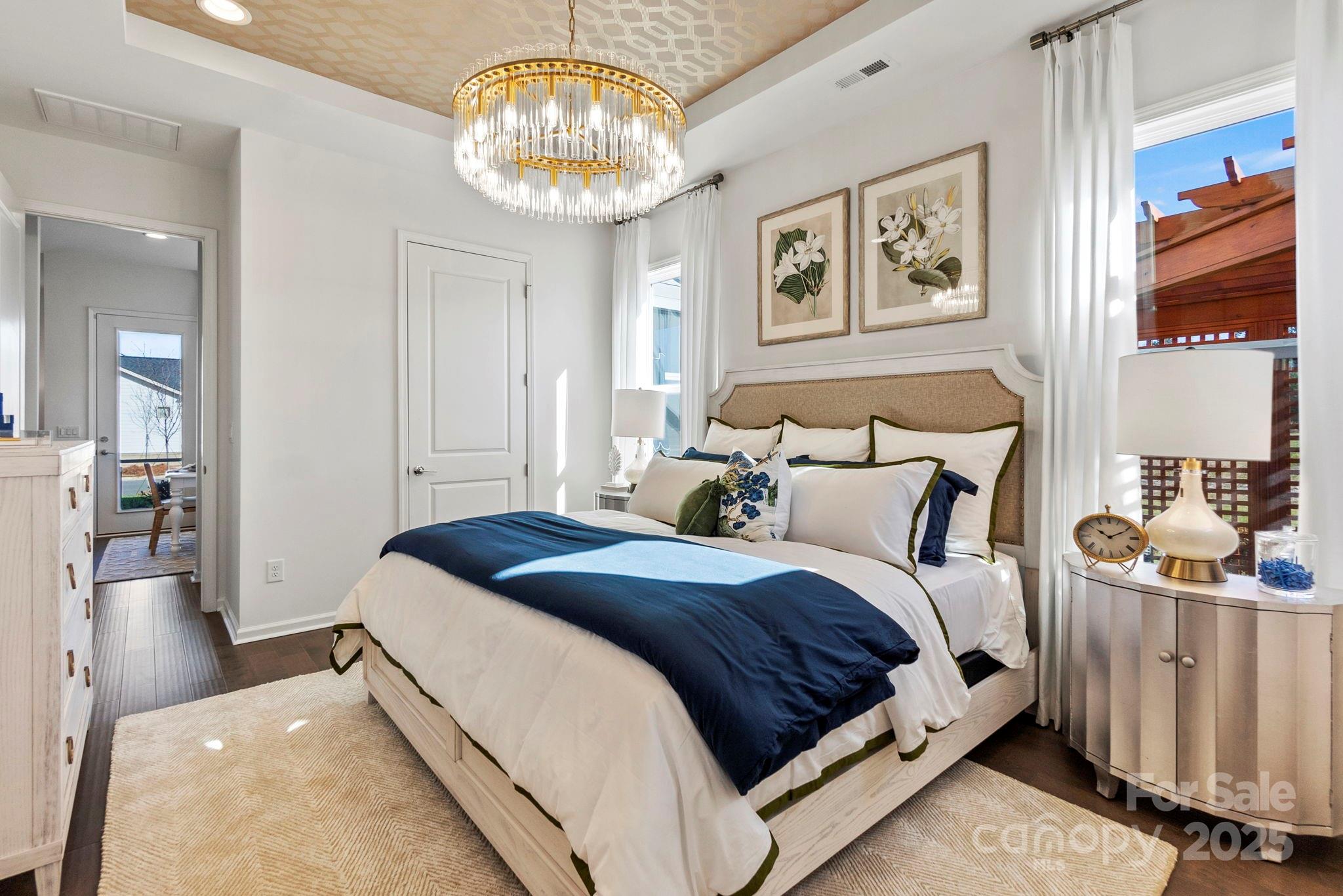 5068 Duval Circle Tega Cay, SC 29708 - Photo 17 of 41 a spacious bedroom with a bed and a chandelier