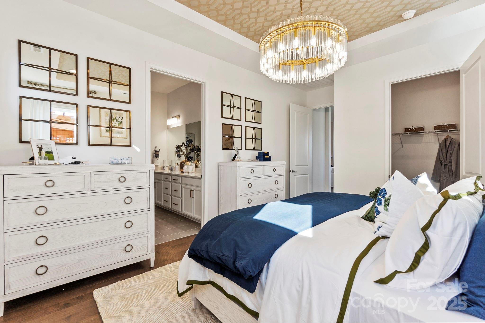 5068 Duval Circle Tega Cay, SC 29708 - Photo 18 of 41 a bedroom with a bed and a chandelier