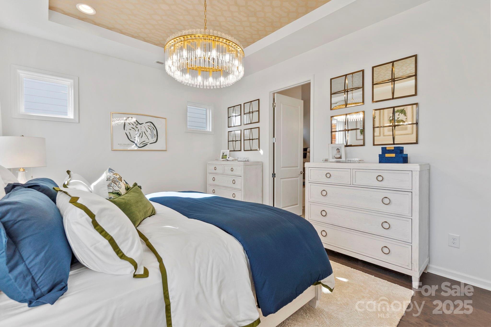 5068 Duval Circle Tega Cay, SC 29708 - Photo 19 of 41 a bedroom with a bed and a chandelier