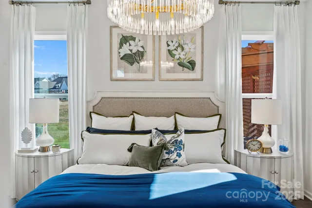 a bedroom with a bed and a lamp on table