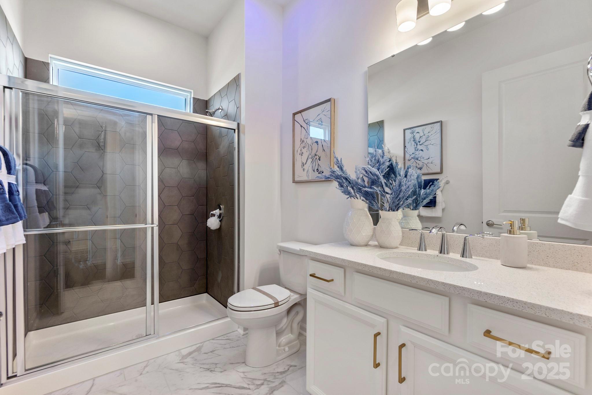 5068 Duval Circle Tega Cay, SC 29708 - Photo 26 of 41 a bathroom with a granite countertop sink toilet and shower