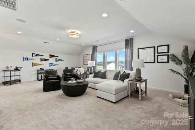 a bedroom with furniture and a large window