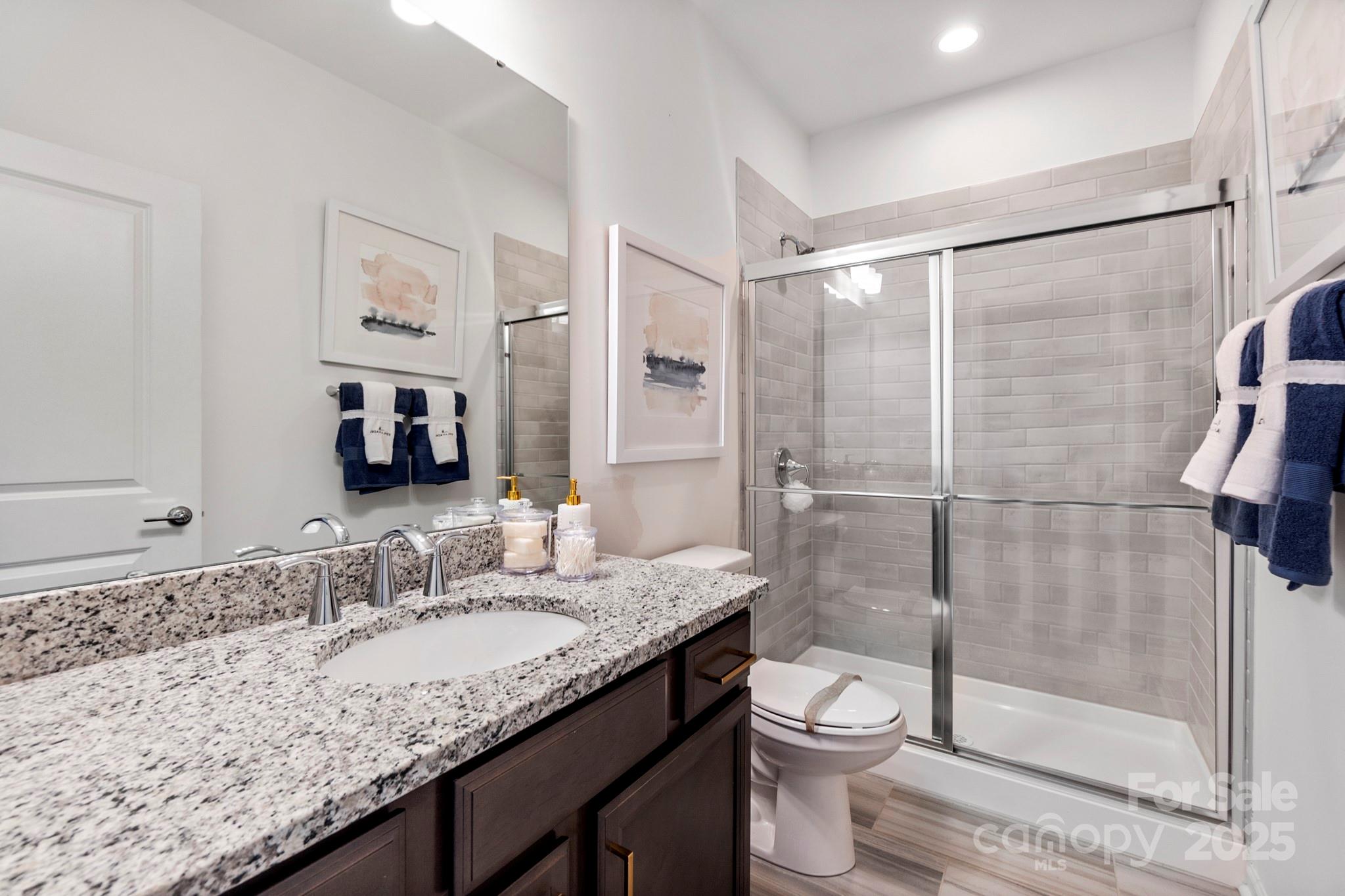 5068 Duval Circle Tega Cay, SC 29708 - Photo 32 of 41 a bathroom with a granite countertop sink toilet and shower