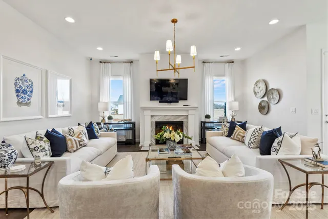 a living room with furniture a fireplace and a flat screen tv