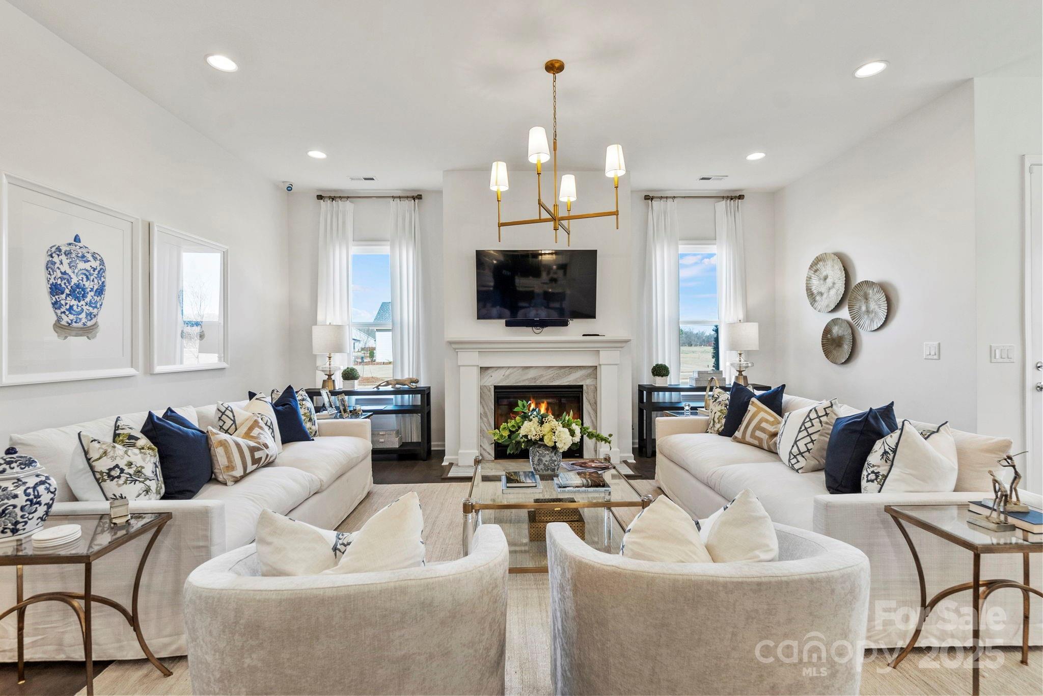 5068 Duval Circle Tega Cay, SC 29708 - Photo 8 of 41 a living room with furniture a fireplace and a flat screen tv