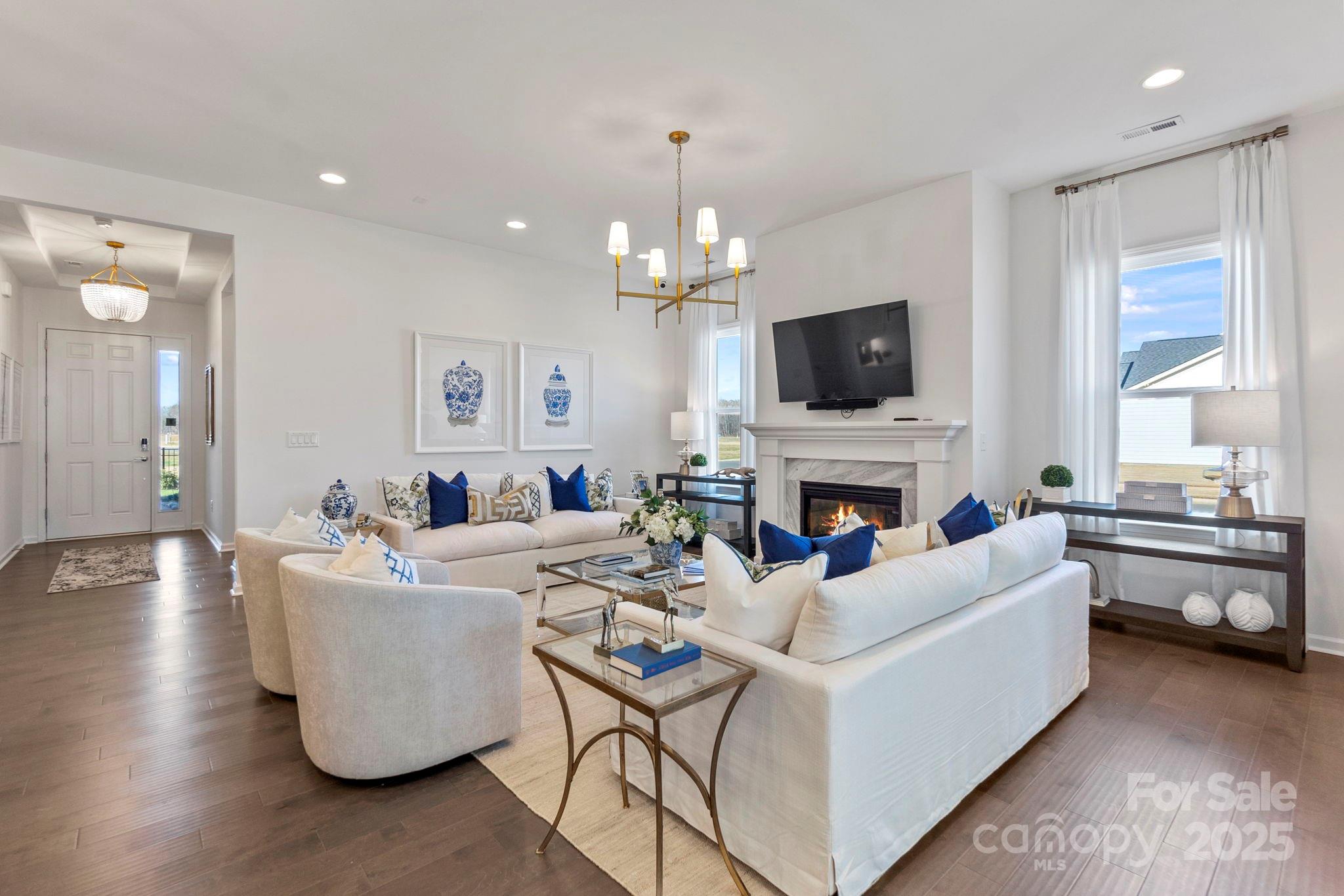 5068 Duval Circle Tega Cay, SC 29708 - Photo 9 of 41 a living room with fireplace furniture and a flat screen tv