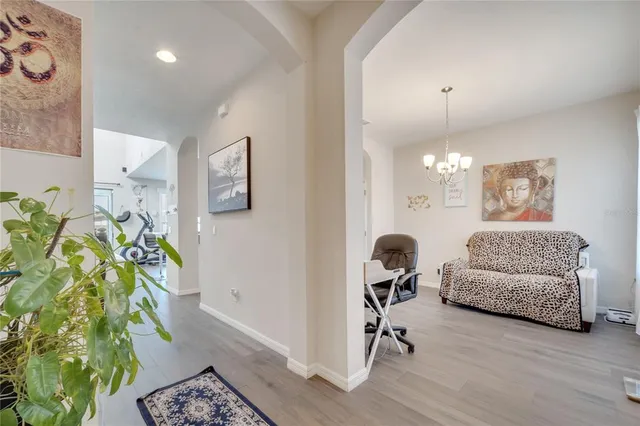 a bathroom with a toilet and a potted plant