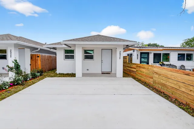 a front view of a house with trees
