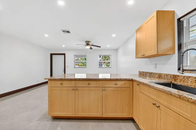 a view of a kitchen from a hallway