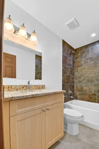 an empty room with chandelier fan and closet