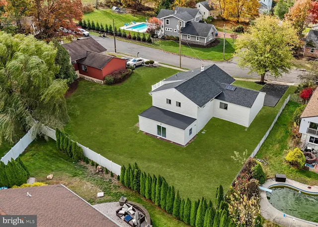 an aerial view of a house with a garden and swimming pool