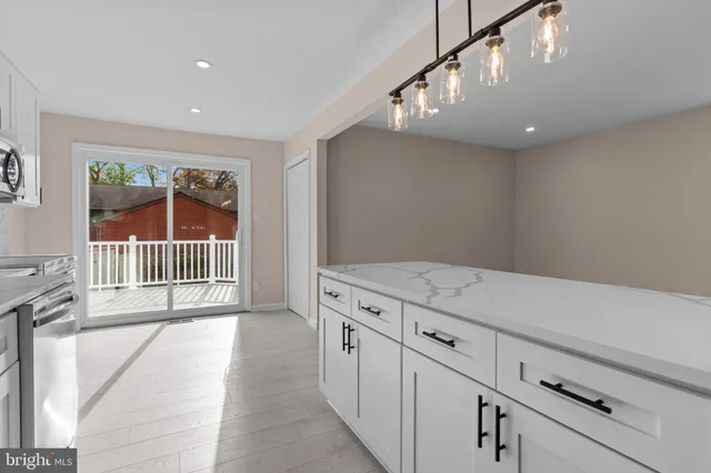 a view of a hallway with entryway and stairs