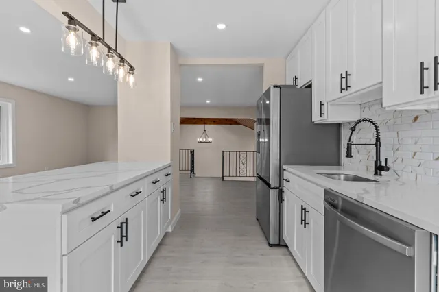 a kitchen with stainless steel appliances a sink and cabinets