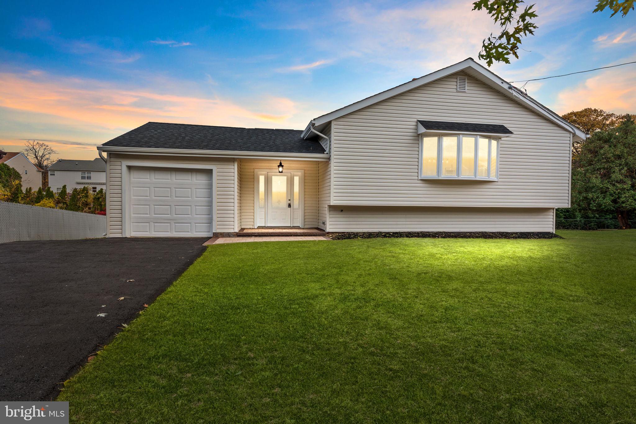 100 East Endfield Road Feasterville-Trevose, PA 19053 - Photo 2 of 53 a front view of a house with a yard and garage