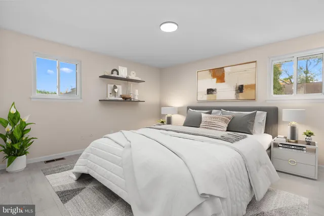 a bedroom with a bed and a potted plant