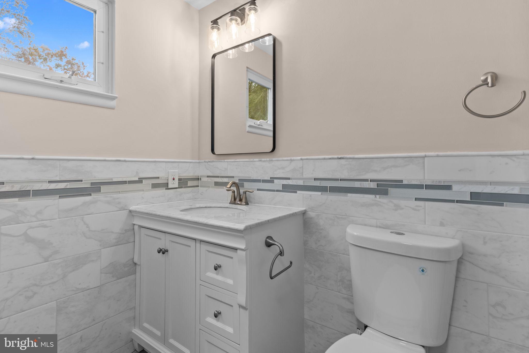 100 East Endfield Road Feasterville-Trevose, PA 19053 - Photo 24 of 53 a bathroom with a granite countertop toilet sink and mirror