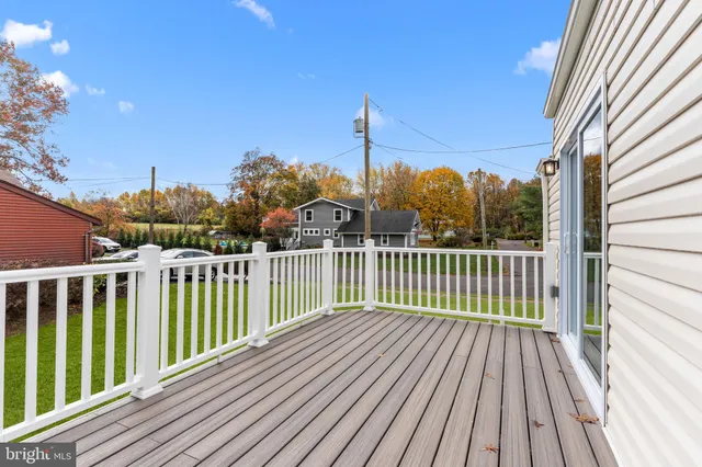 a view of an house with backyard space and balcony