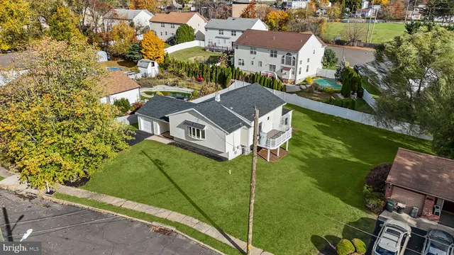an aerial view of a house with garden space and street view