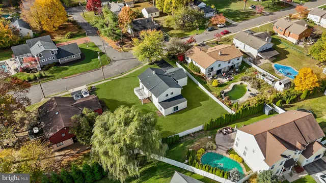 an aerial view of a house with a garden and swimming pool