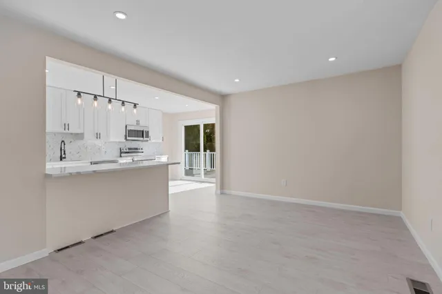 a large white kitchen with white cabinets and a stove