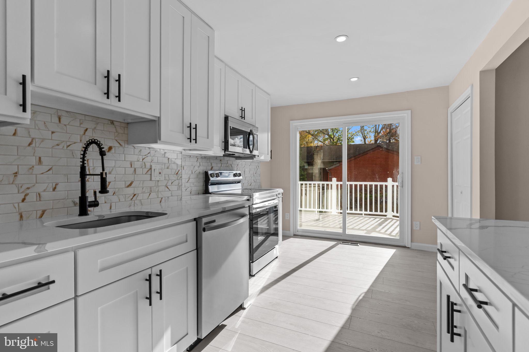 100 East Endfield Road Feasterville-Trevose, PA 19053 - Photo 10 of 53 a kitchen with stainless steel appliances granite countertop a stove a sink and a refrigerator