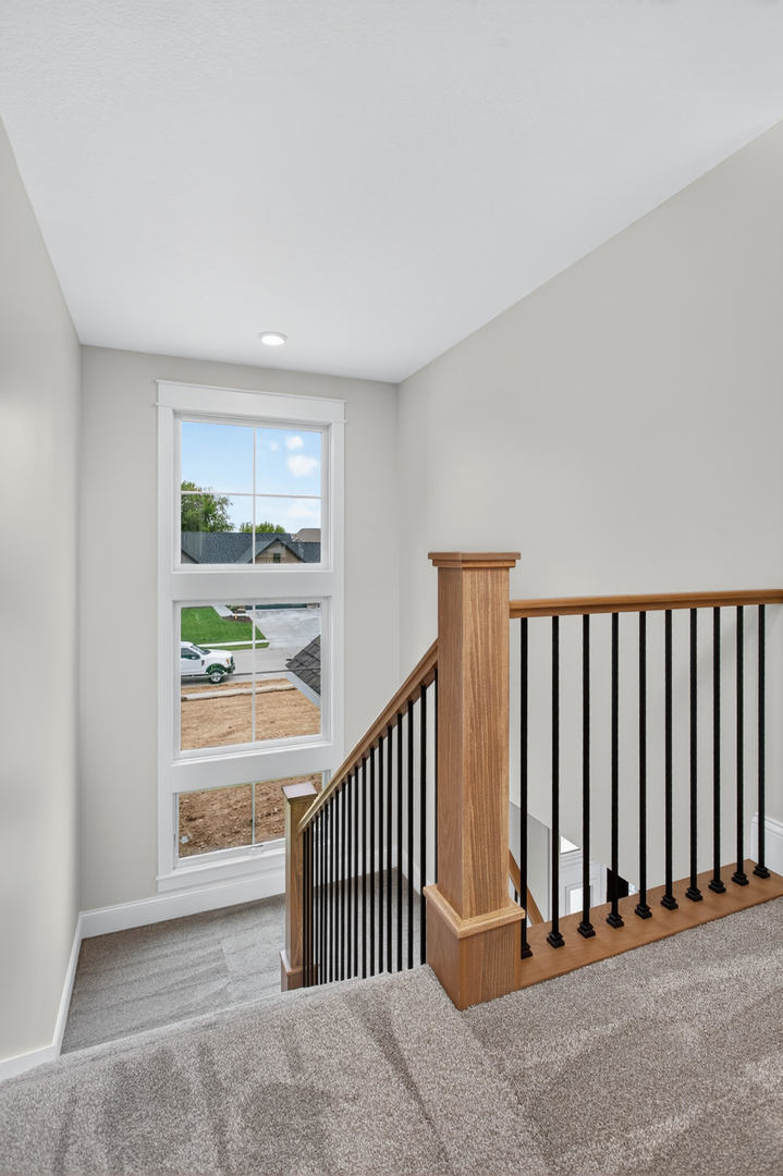 6928 Wilderness Pointe Bettendorf, IA 52722 - Photo 35 of 48 a view of a hallway with wooden floor and windows