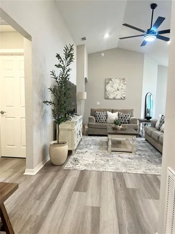 a living room with furniture and a potted plant
